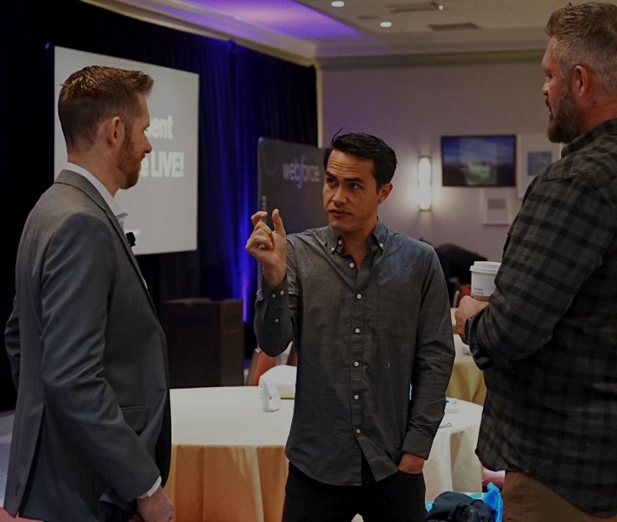 Cody Bramlett talking with supplement founders at an event